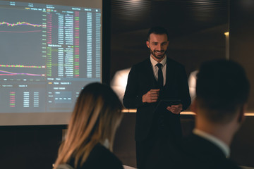 Wall Mural - The man standing near the large display on the business meeting