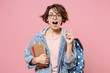 Excited girl student in denim clothes glasses backpack isolated on pastel pink background. Education in high school university college concept. Hold books pointing index finger up with great new idea.