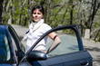 © Mats Silvan - Elegant and Proud Woman Standing Close to a Car.