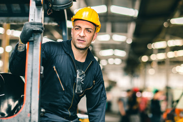 Wall Mural - Portrait of Caucasian factory worker handsome smart with safety clothes and yellow helmet.