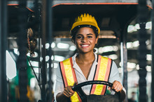 Women Labor Worker At Forklift Driver Position With Safety Suit And Helmet Happy Smile Enjoy Working In Industry Factory Logistic Shipping Warehouse.