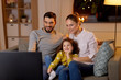 © Syda Productions - family, leisure and people concept - happy smiling father, mother and little daughter watching tv at home at night