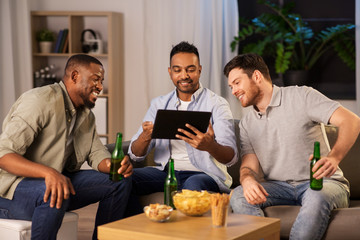 Wall Mural - friendship, leisure and people concept - male friends with tablet pc computer drinking beer at home at night