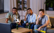 © Syda Productions - friendship, sports and entertainment concept - disappointed male friends with soccer ball and vuvuzela watching football game at home