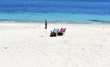 © JB - Beach chairs and umbrella on a beach with white sand and turquoise water. Spain.