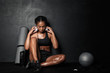 © Drobot Dean - Image of young african american sportswoman with fitness equipment