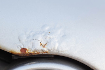 Corrosion and rust on the hood of a car. The concept of anti-corrosion treatment of the car body, macro