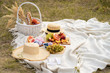Stylish summer picnic on a white blanket.