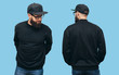Handsome hipster guy with beard wearing black blank hoody or sweatshirt from front and back and black cap with space for your logo or design on blue background. Mockup for print