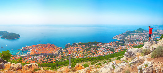 Wall Mural - Aerial panoramic view of the old town of Dubrovnik with famous Cable Car on Srd mountain on a sunny day.