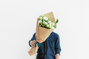 man in shirt  holding white flower bouquet