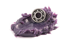 Automotive And Industrial Close Up Grease, Ball Bearing Put On The Lithium Complex  Multipurpose Grease NLGI 3 (Purple) Isolated On White Background. Industrial Concept.