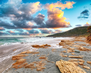 Wall Mural - Fantastic view of Capo Carbonara beach with turquoise water and rocks.