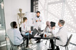 © sofiko14 - Chemical lab workers, doctors, scientists having a meeting. Asian man explaining a new project concept for his colleagues. Scientific discovery, medical research, scientists teamwork