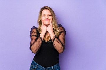 Young caucasian woman isolated on purple background doubting between two options.