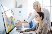 Side View Portrait Of Two Businesswomen Using Computer In Design Agency