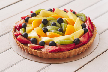 fruit tart on white wood table