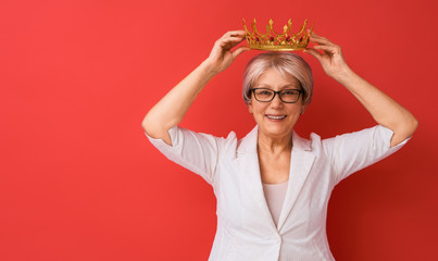 Wall Mural - senior woman posing on red background