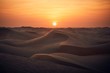 Sand dunes in desert landscape at sunset