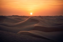 Sand Dunes In Desert Landscape At Sunset