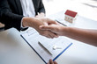 © Thitiphat - Real estate agent are shaking hands after good deal and giving house, keys to customer after signing contract to buy house with approved property application form