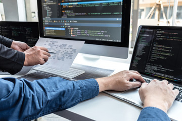 team of developer programmer working on project in software development computer in it company offic