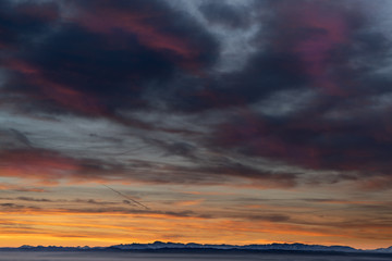 Wall Mural - sunrise at the lake on a pier with panorama view to the mountains