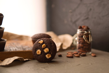 Canvas Print - Chocolate muffins with nuts on a wooden table. delicious sweet dessert. rustic style.