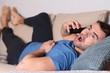 © ajr_images - Shocked man calling by phone from the sofa