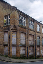 A Street Corner View Of Closed And Boarded Up Old Abandoned Industrial And Office Buildings In The Little Germany Area Of Bradford