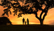 © kieferpix - Family waking together in nature sunset holding hands.