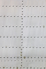 Metal surface with rivets as background