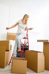 Wall Mural - People moving new place and repair concept happy young woman with many boxes