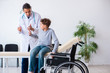 © Elnur - Young male doctor pediatrist and boy in wheel-chair