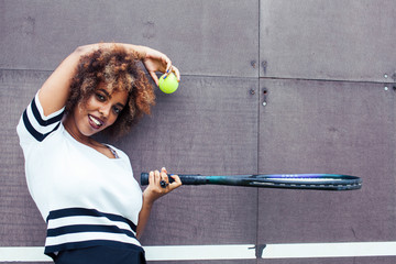 young stylish afro-american girl playing tennis, sport healthy lifestyle people concept