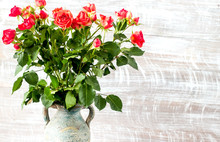 Red Roses In Vase On Wall Background Mock Up