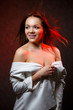 © DSMT - beautiful girl unbuttones a white jacket and smiles beautifully