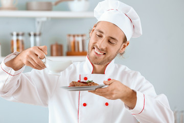 Canvas Print - Male chef cooking in kitchen