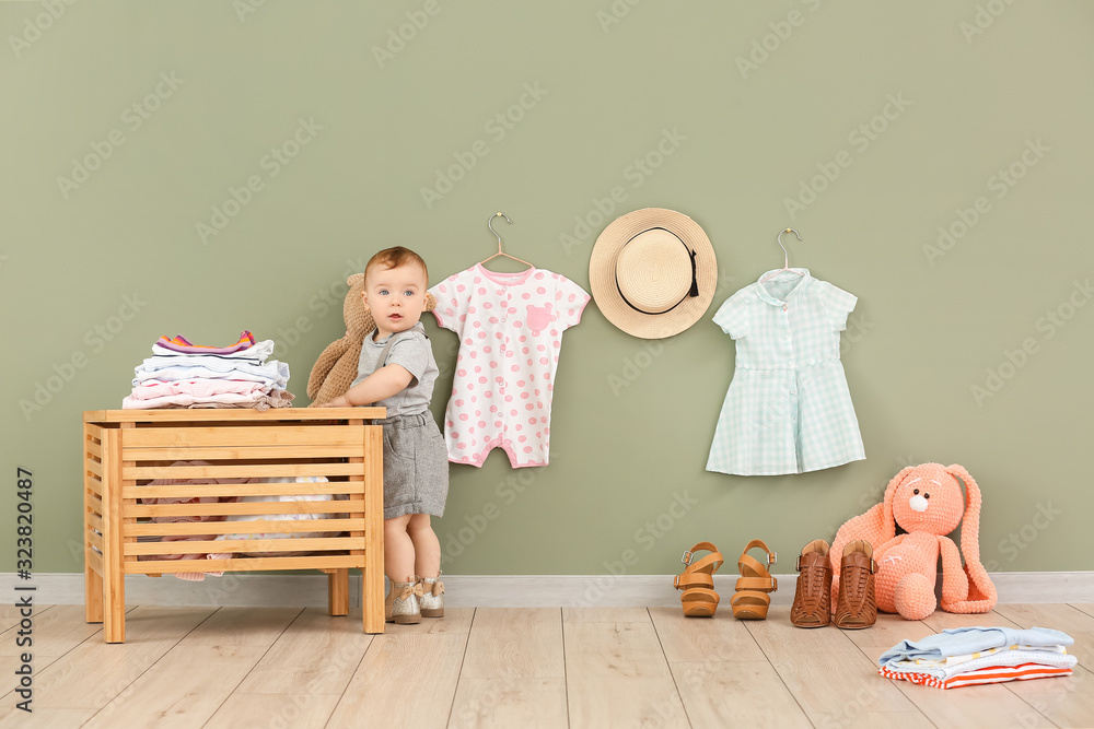 Cute baby with stylish clothes at home