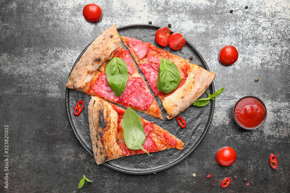 Plate with slices of tasty pizza on dark background