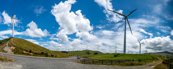 Massive wind turbine towers generating electricity in beautiful rural agricultural  countryside