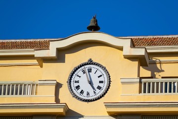 Canvas Print - Nice vintage clock on the facade of an old building in the historical center of a city in south of E