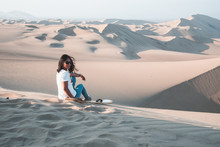 Woman Enjoying Sand Boarding At Huachina Desert Sand Dunes Peru South America