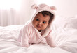 © New Africa - Cute African American baby on bed at home