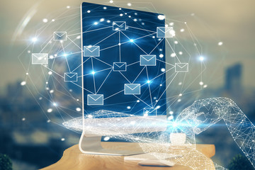 Desktop computer background in office and flying envelops hologram drawing. Multi exposure. Electronic mail concept.