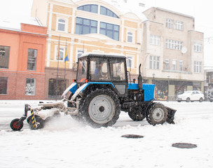  Snowplow truck removing snow on the street after blizzard. Intentional motion blur