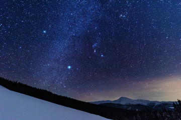 Wall Mural - a bright starry night in the mountains with the milky way in the sky, venus and millions of stars hi