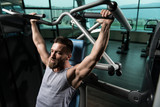 Fototapeta Przeznaczenie - Bodybuilder Doing Heavy Weight Exercise For Shoulders