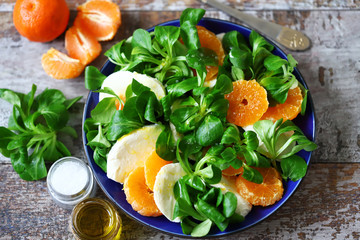 Healthy bright salad with mozzarella and mandarin. Citrus Salad. Diet concept.