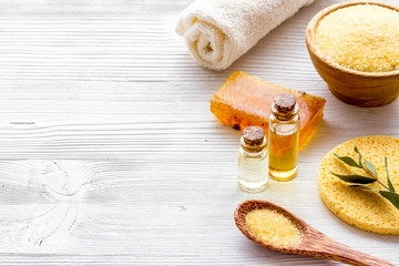 Spa set with mineral salt and oil on white wooden background copy space